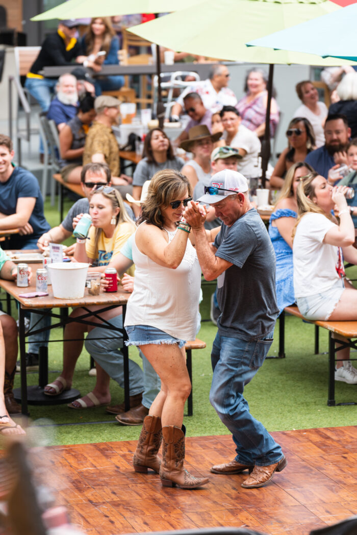 Couple dancing at Legacy Hall Boots & BBQ Memorial Day party