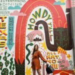 Michelle Joy, Harbors and Havens influencer in front of Shops at Legacy East Howdy Texas mural