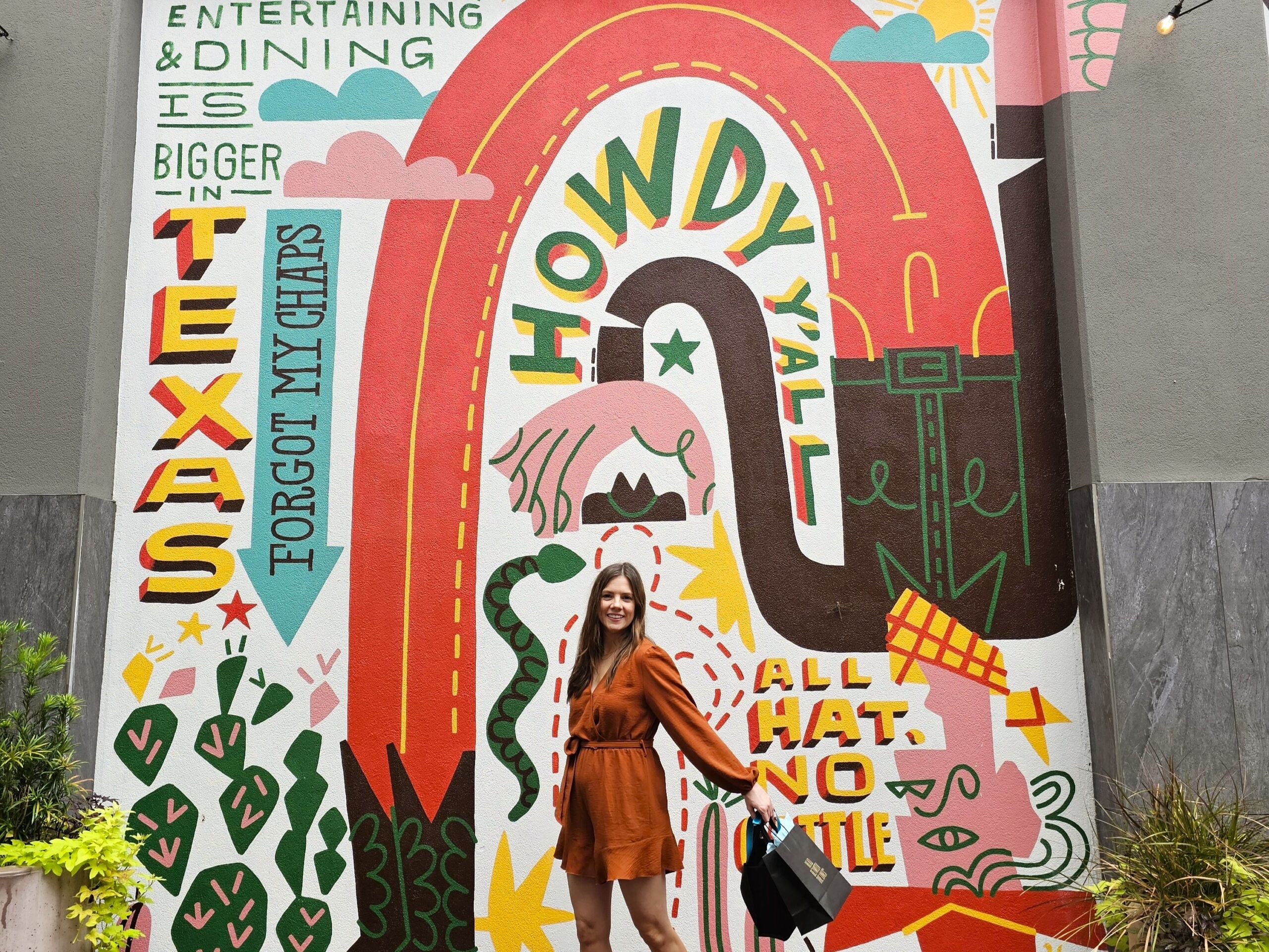 Michelle Joy, Harbors and Havens influencer in front of Shops at Legacy East Howdy Texas mural