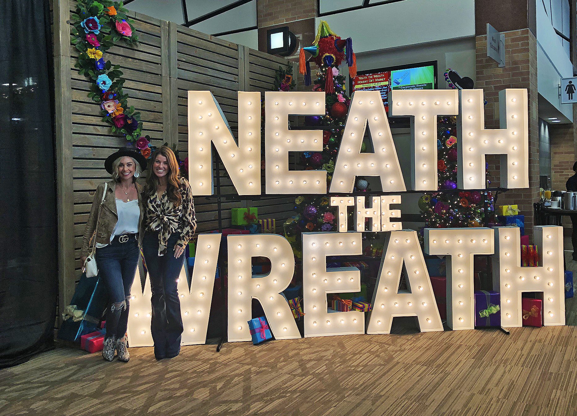 Neath the Wreath Holiday Gift Market ladies in front of marquee letters