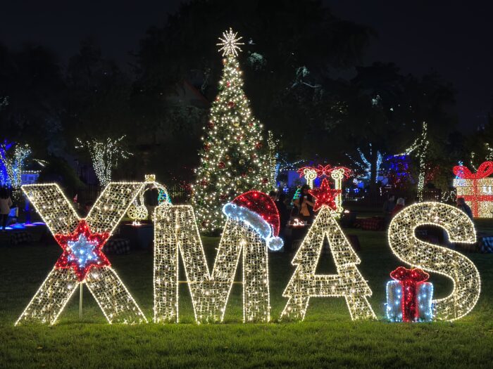 Heritage Farmstead Museum Lights on the Farm XMAS icon letters with Christmas tree.