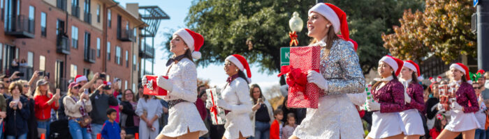 Plano, TX Holiday Event Guide - Holiday Parade drill team marching with presents