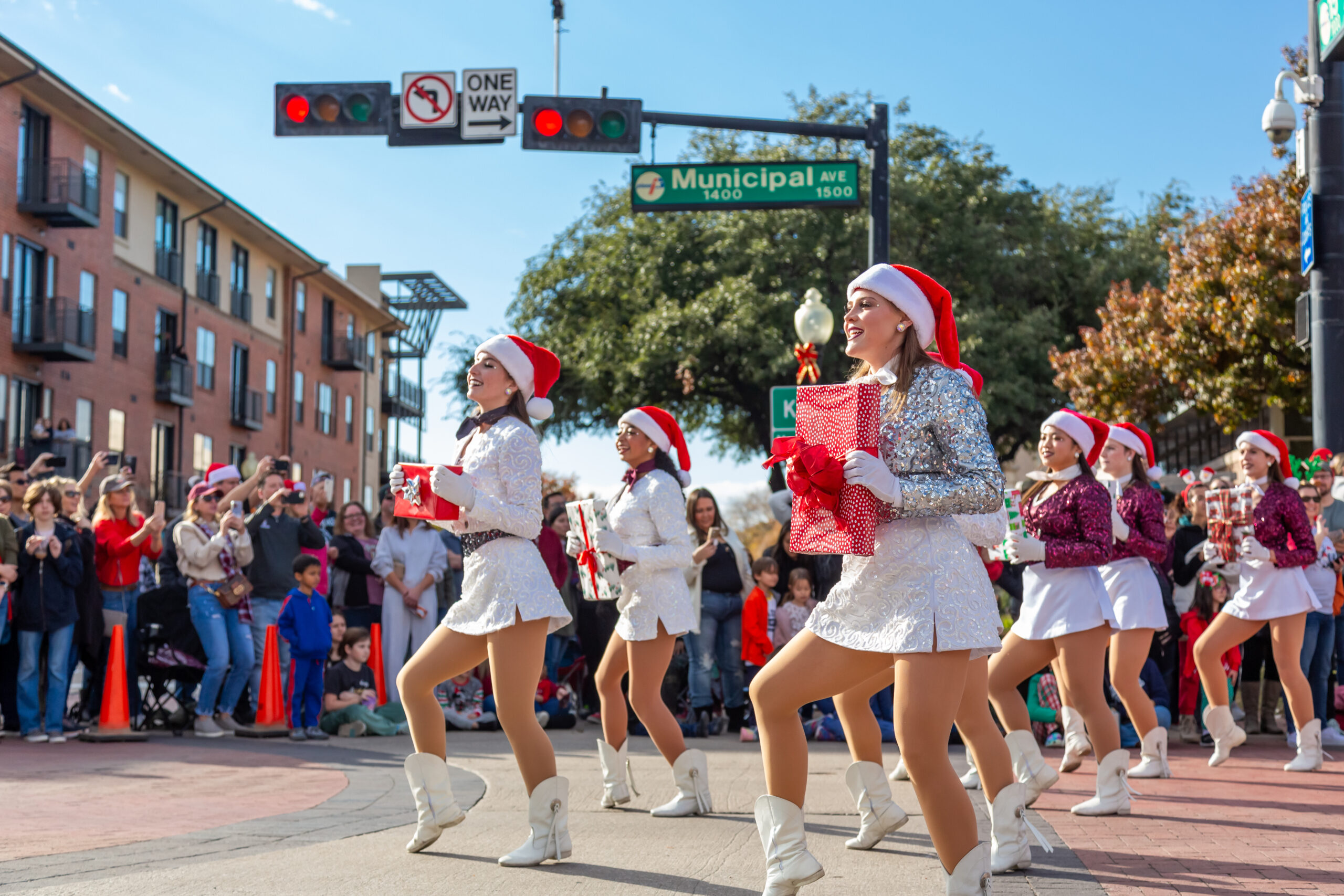 Plano, TX Holiday Event Guide - Holiday Parade drill team marching with presents